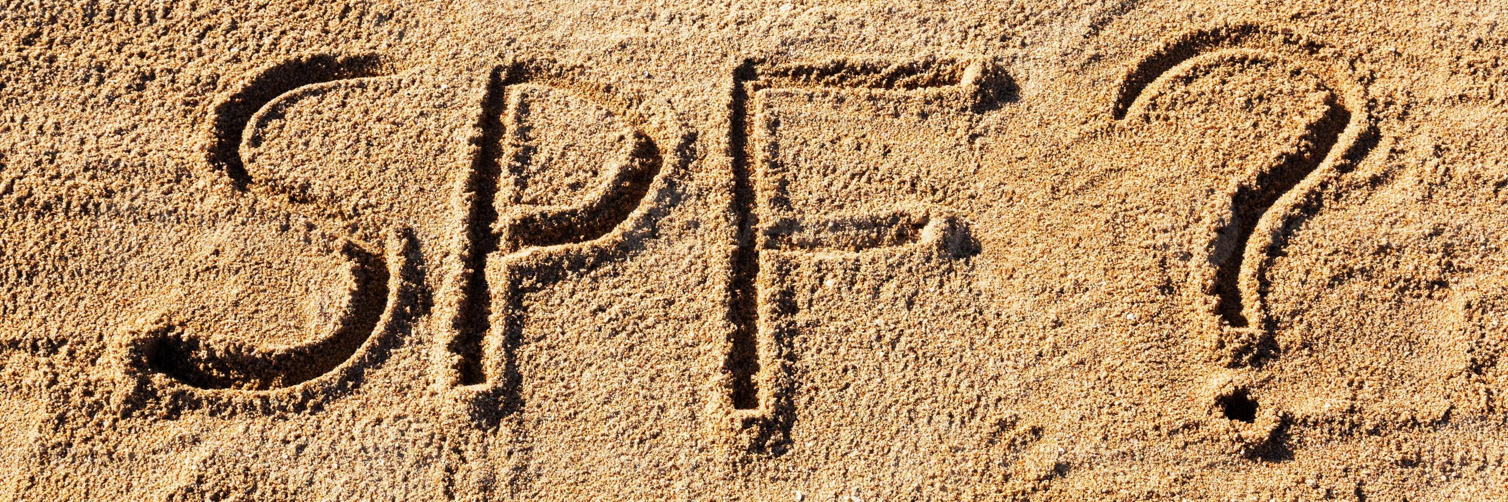 Sun protect factor concept. SPF word written the beach with question mark photo