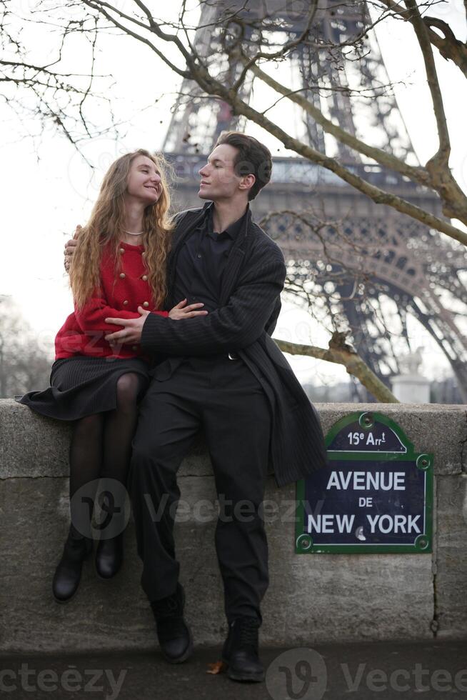 Romantic Couple Posing Near Eiffel Tower in Paris photo