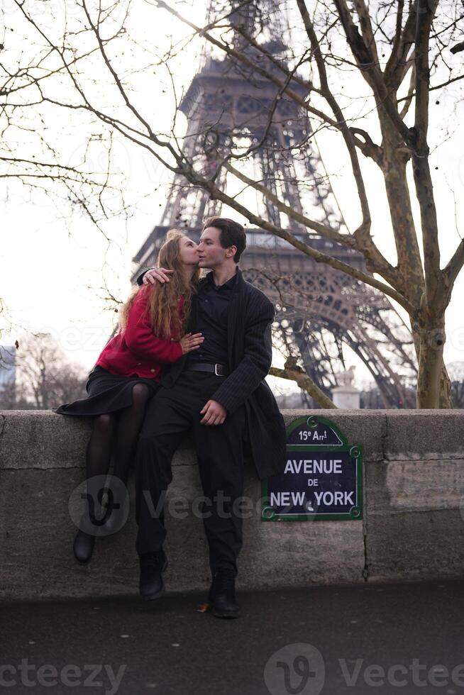 Couple shares a romantic kiss near Eiffel Tower in Paris photo