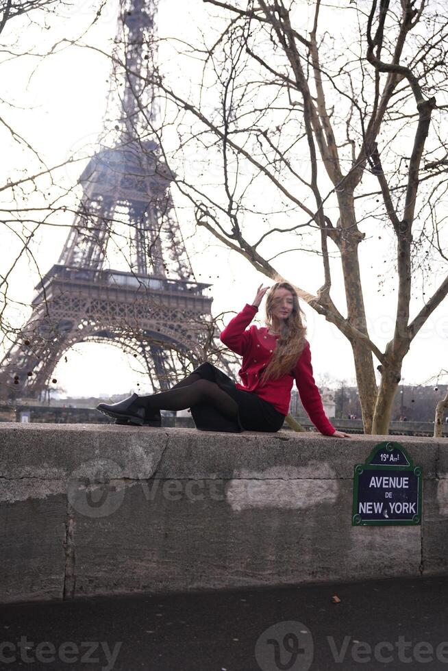Elegant woman relaxing near Eiffel Tower in Paris photo