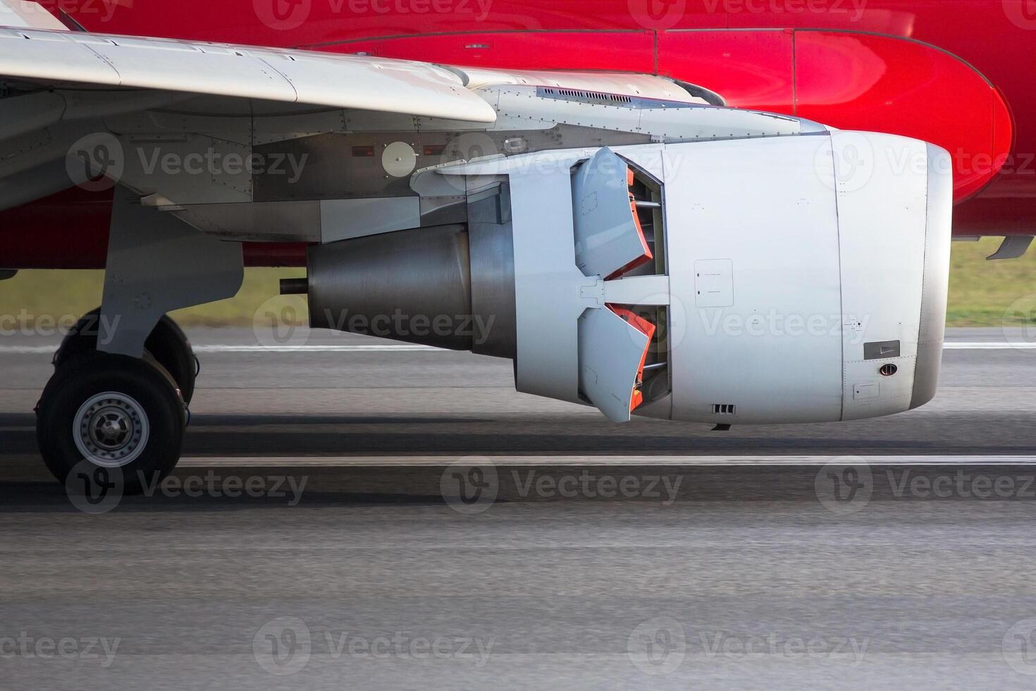 Narrow-body airplane engine in reverse closeup, side view. Backward thrust of the aircraft engine photo