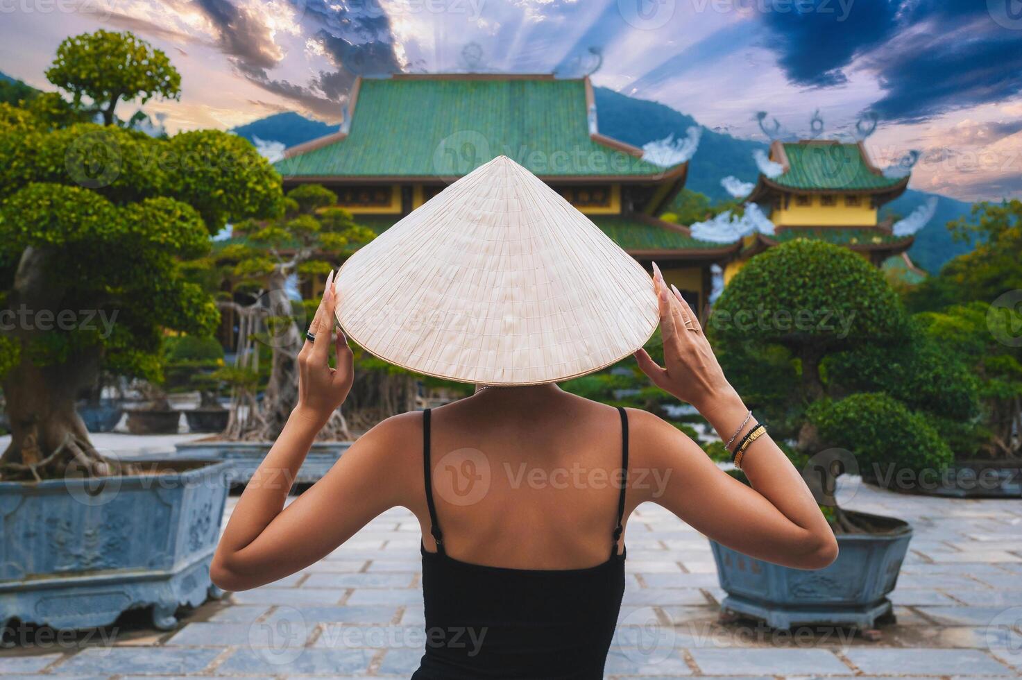 back of woman tourist traveler at Buddhist temple at Linh Ung Pagoda in Da Nang in Vietnam. Concept of travel and tourism in Asia photo