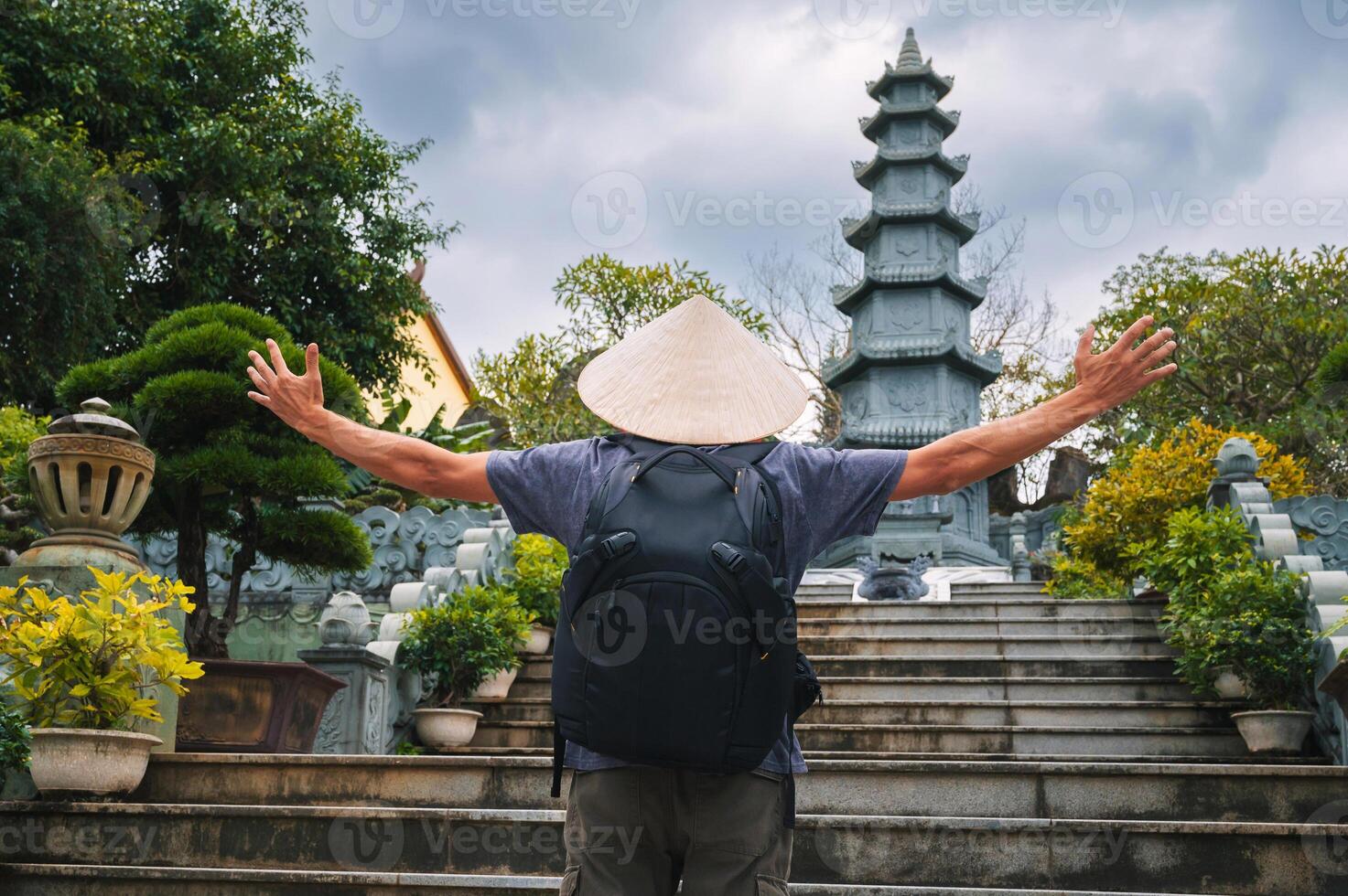 back of a male tourist traveler at Linh Ung Pagoda in Da Nang in Vietnam. The concept of travel and tourism in Asia photo