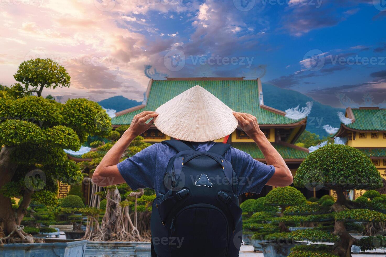 back of male tourist traveler at Buddhist temple at Linh Ung Pagoda in Da Nang in Vietnam. Concept of travel and tourism in Asia photo