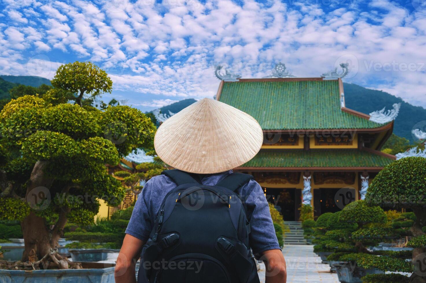 back of a male tourist traveler at a Buddhist temple at Linh Ung Pagoda in Da Nang in Vietnam. The concept of travel and tourism in Asia photo