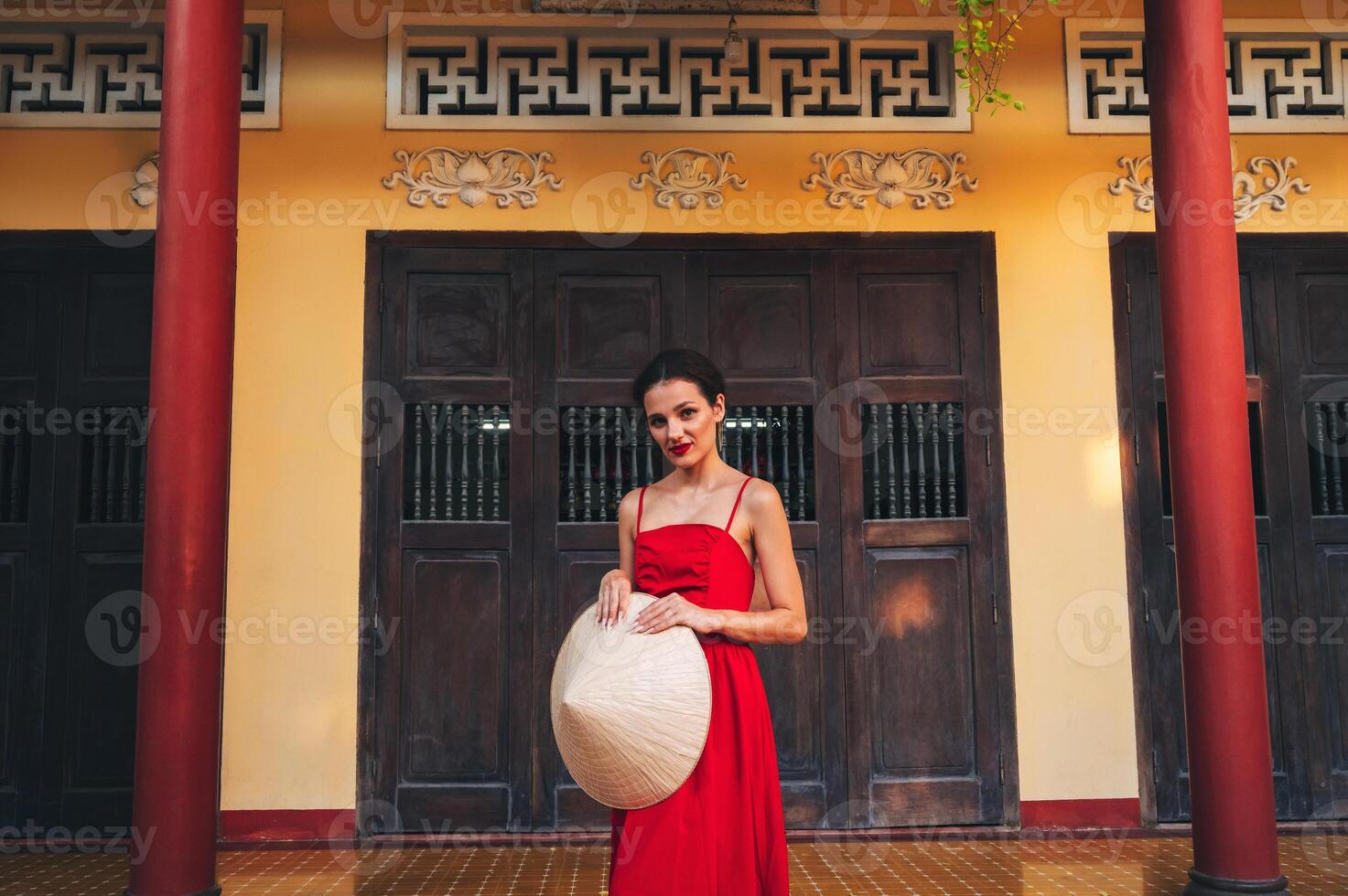 portrait of beautiful young woman tourist in Non La hat at Long Son Pagoda in Nha Trang in Vietnam photo