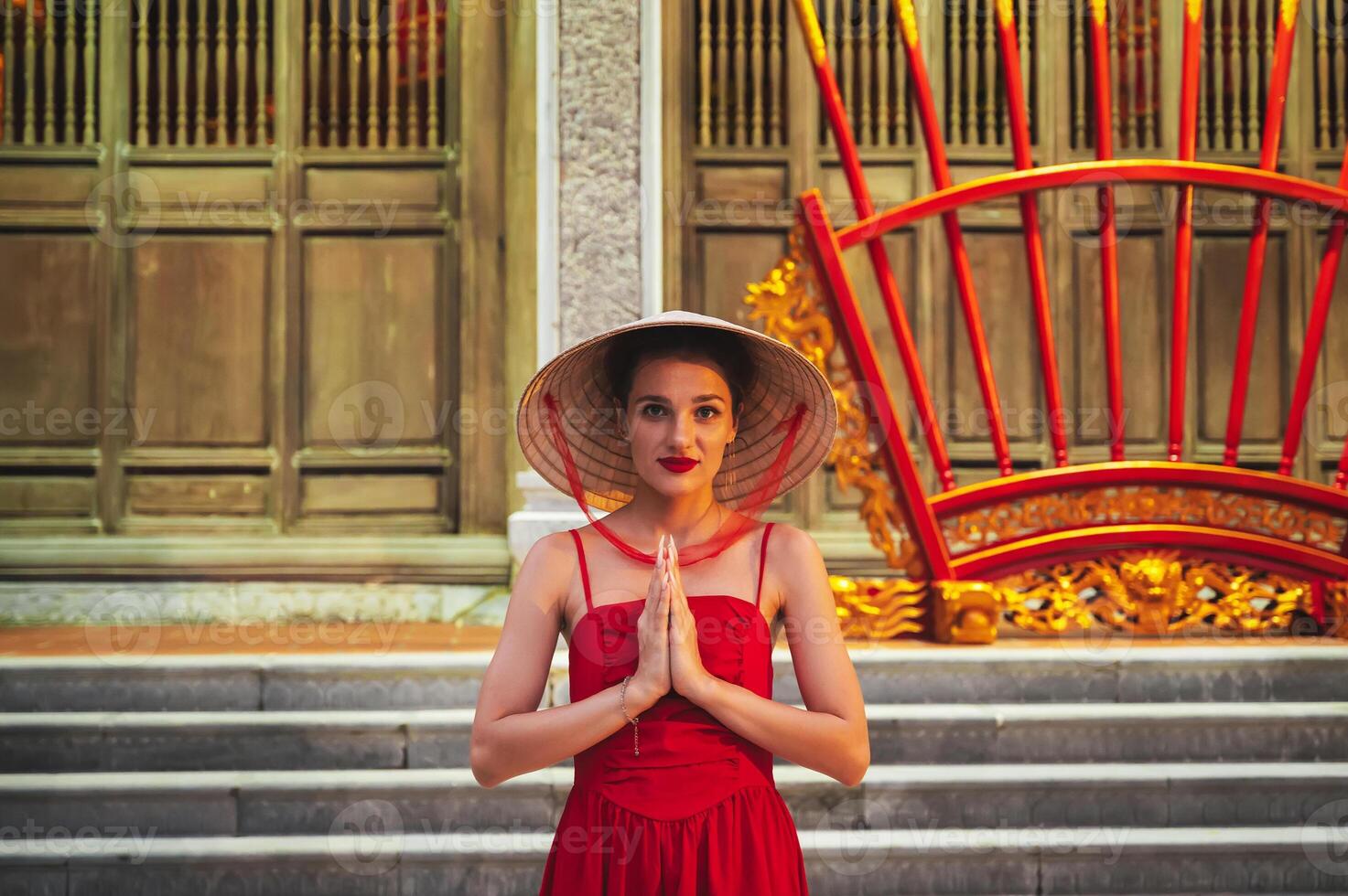 portrait of a young female tourist at Buddhist temple on a pagoda in Vietnam in Asia photo