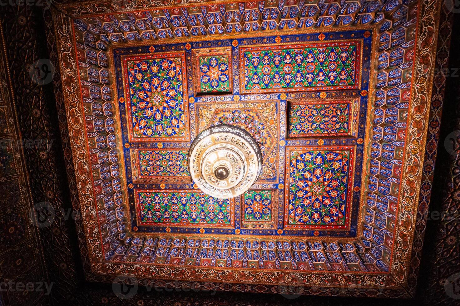 carved wooden painted ceiling with chandelier in the Museum of Art of Uzbekistan with Uzbek ornaments and colorful oriental patterns in Uzbekistan photo