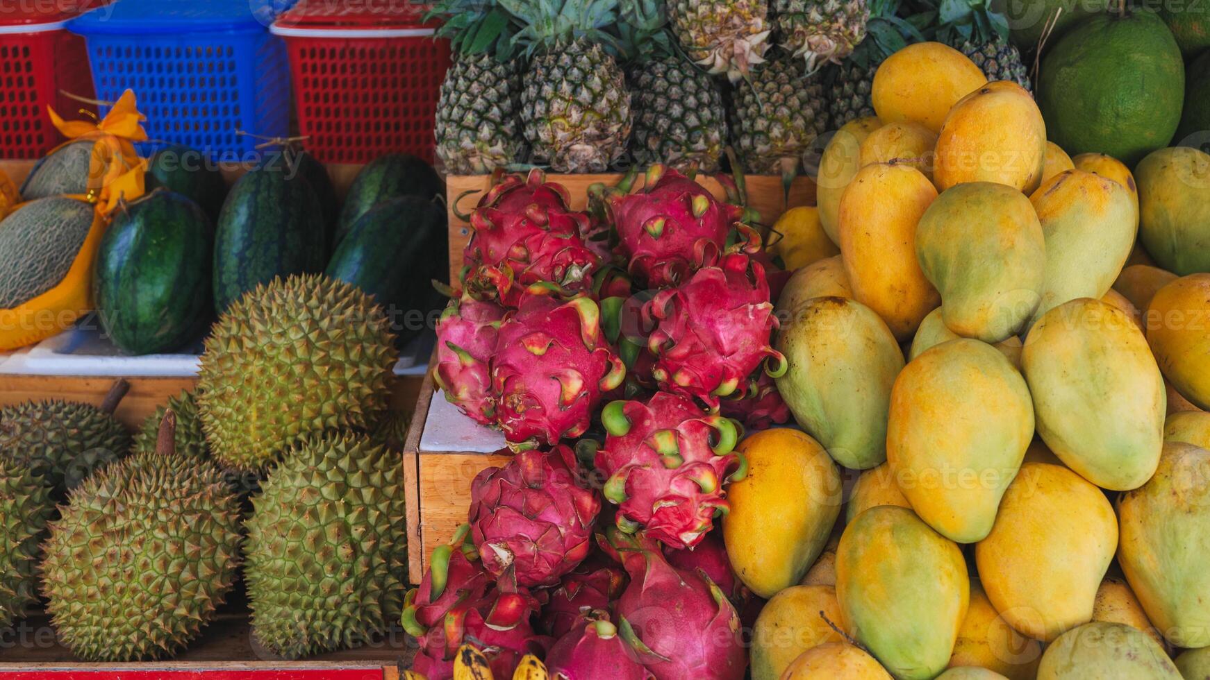 Mango, pitahaya, durian and pineapples on counter in a store in Thailand at a street market. Assortment of sweet ripe exotic tropical Vietnamese fruits photo