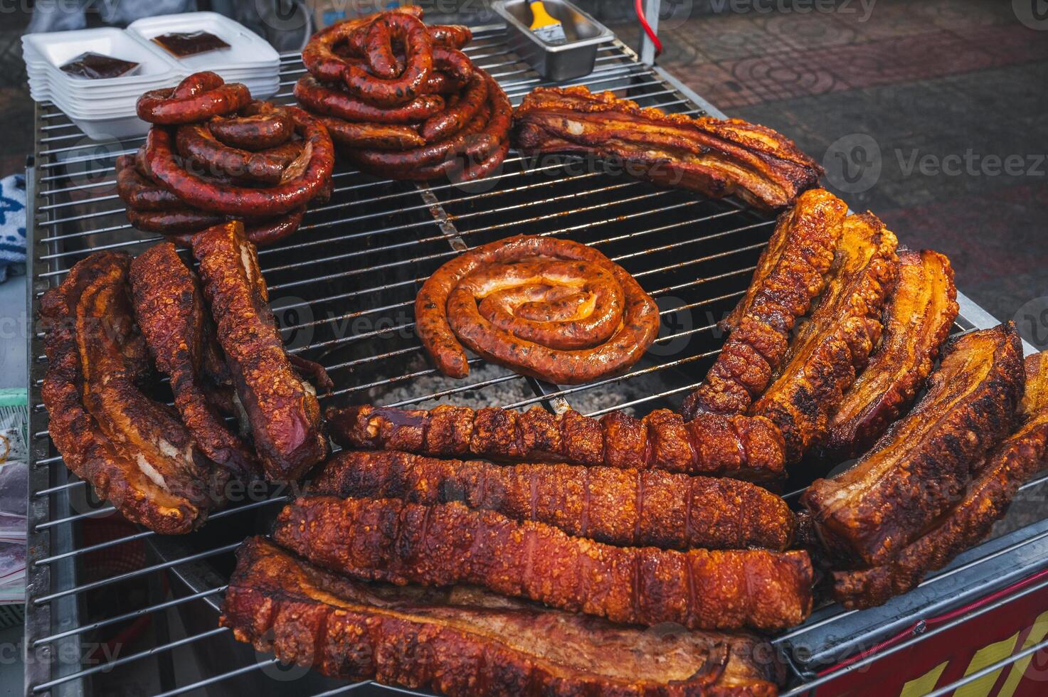 Pork sausage and meat, cooked on a barbecue grill. photo