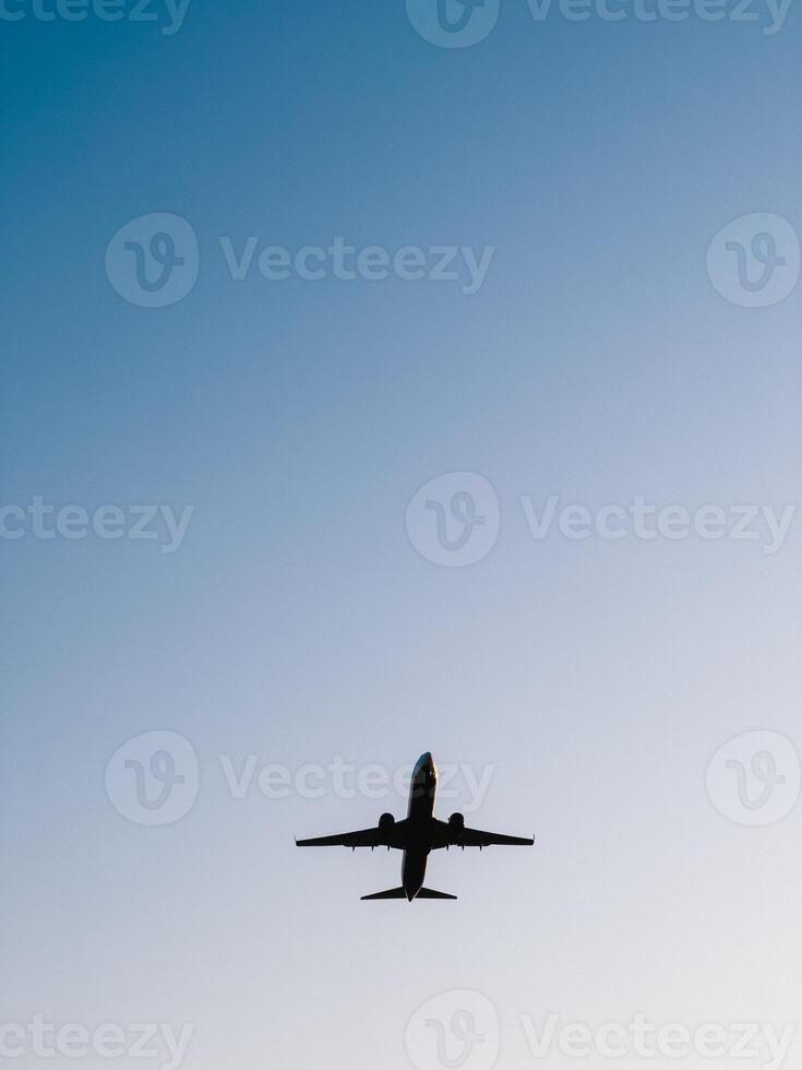 Jet plane soaring high against a clear blue sky, showcasing the beauty of modern air travel and the boundless expanse of the atmosphere, embodying freedom and adventure. limitless aerial exploration photo