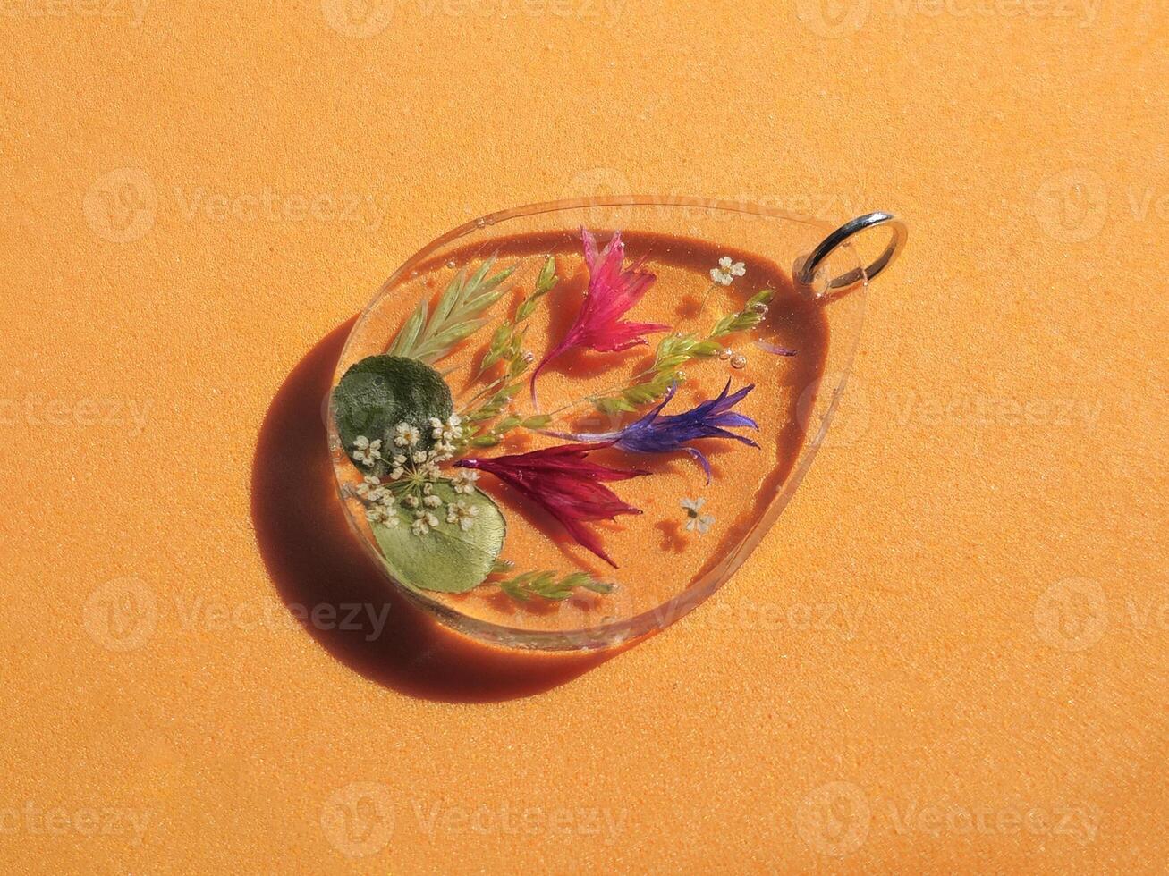 An epoxy resin pendant with dried flowers photo