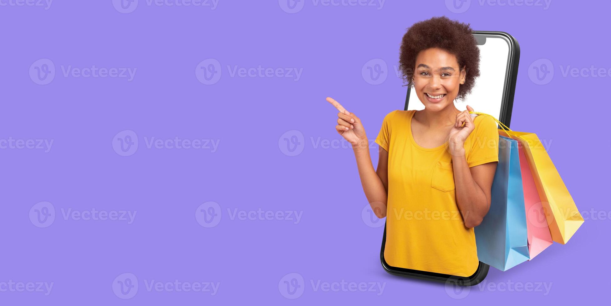 A cheerful person interacts with an online shopping application on their smartphone. They are surrounded by colorful shopping bags, showcasing excitement for digital commerce. photo