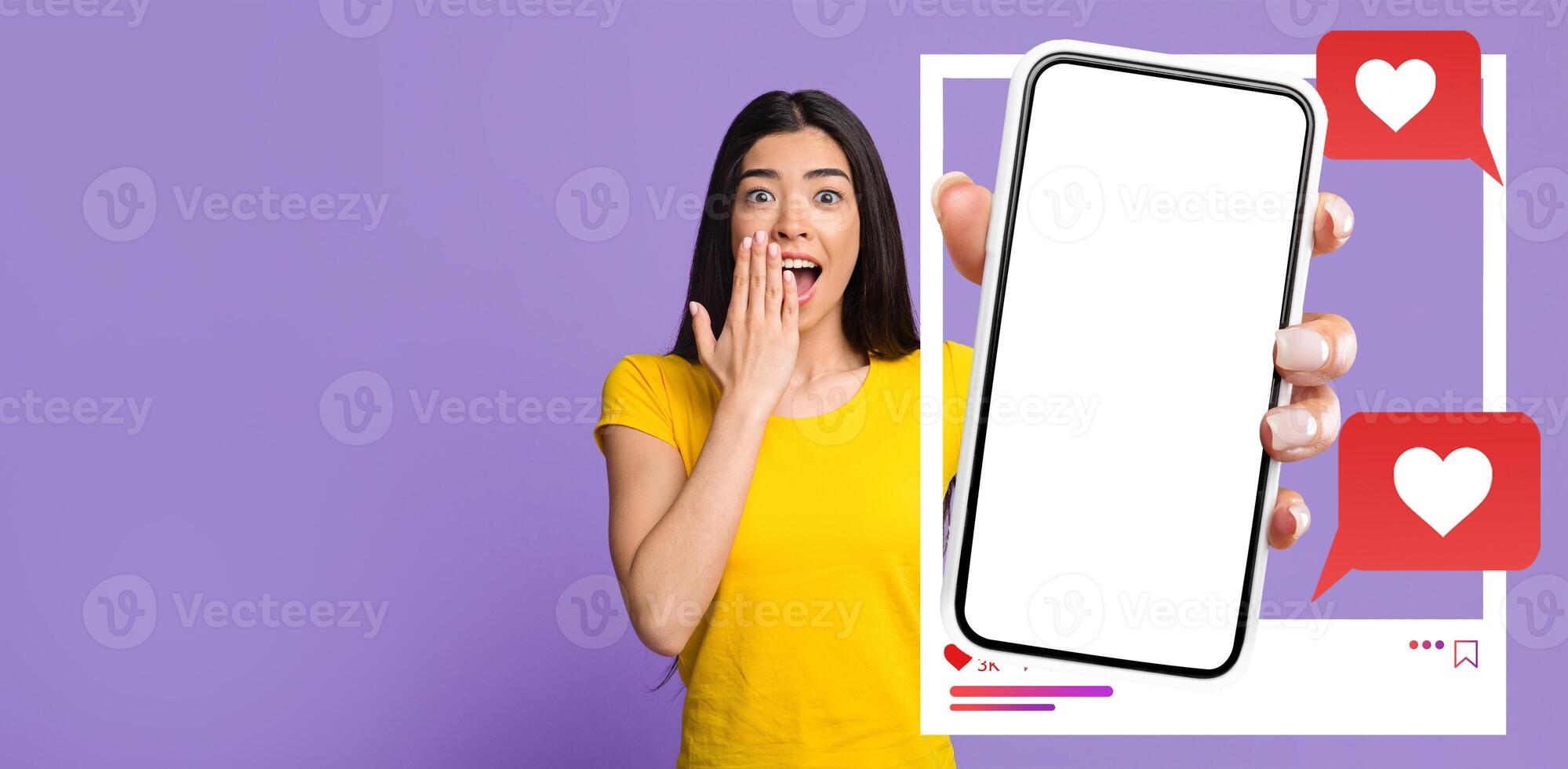 An influencer in a bright yellow shirt expresses surprise while holding a smartphone displaying a blank screen. The background is purple, enhancing the vibrant mood of social media engagement. photo