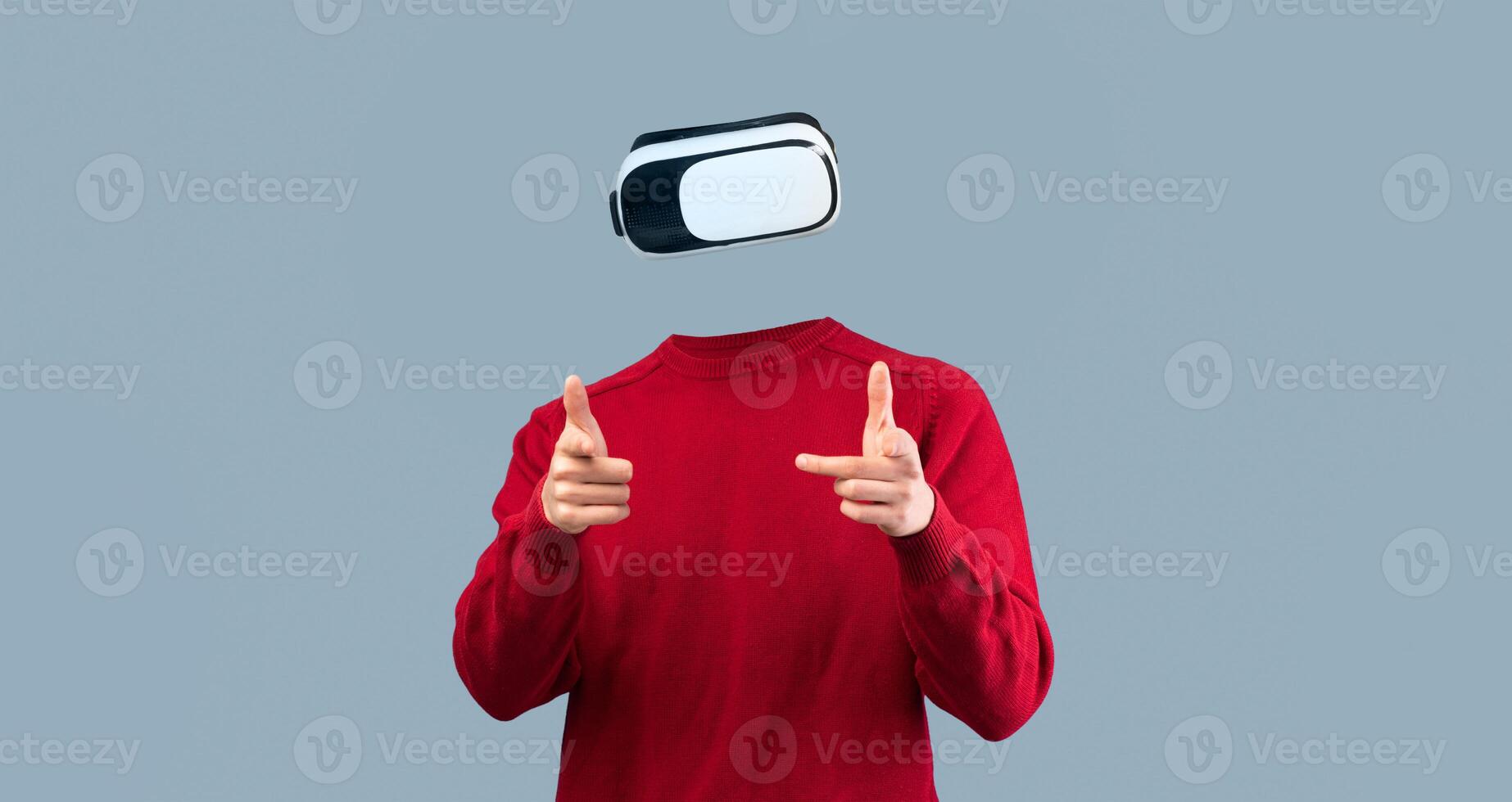 A person uses a virtual reality headset, indicating interaction with a digital environment. The individual is isolated against a neutral background, emphasizing the advanced technology involved. photo