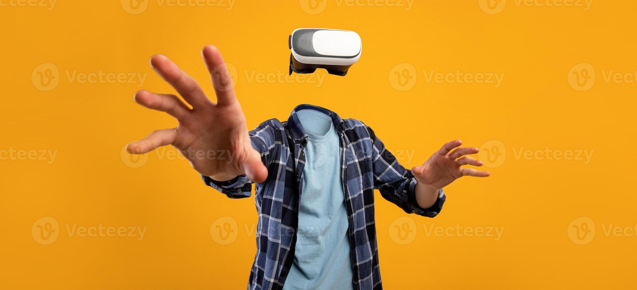 A user engages with virtual reality technology, wearing a headset while reaching out with hands, creating a feeling of immersion. The bright background emphasizes the modern gadget's appeal. photo
