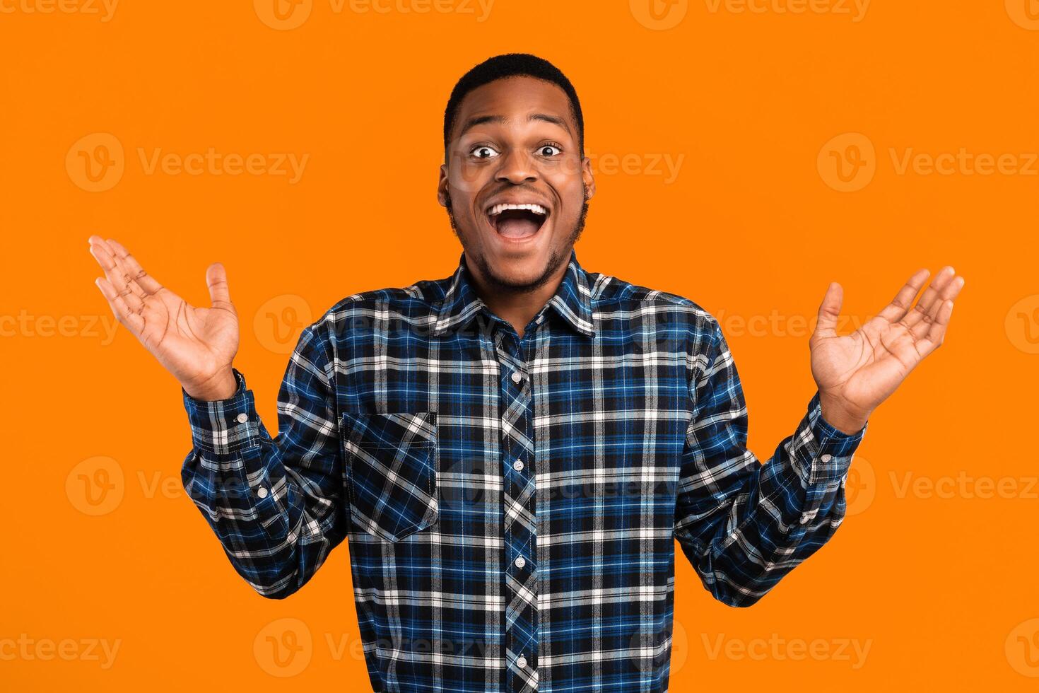 Wow. Funny African Guy Shouting In Excitement Posing With Opened Mouth Over Yellow Background. Surprised Emotion, Facial Expressions. Studio Shot photo