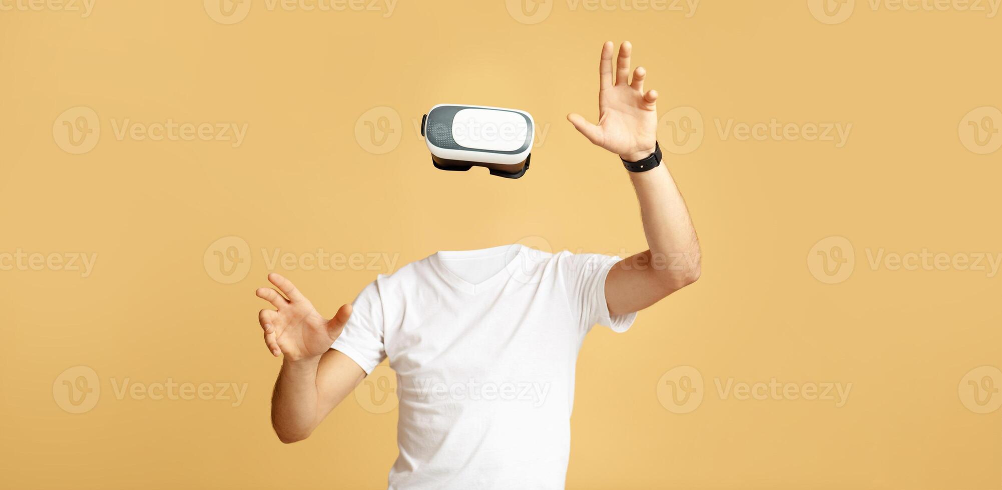 A person wearing a virtual reality headset engages with the technology, appearing without a visible head or face. The isolated environment emphasizes the immersive experience of modern VR. photo