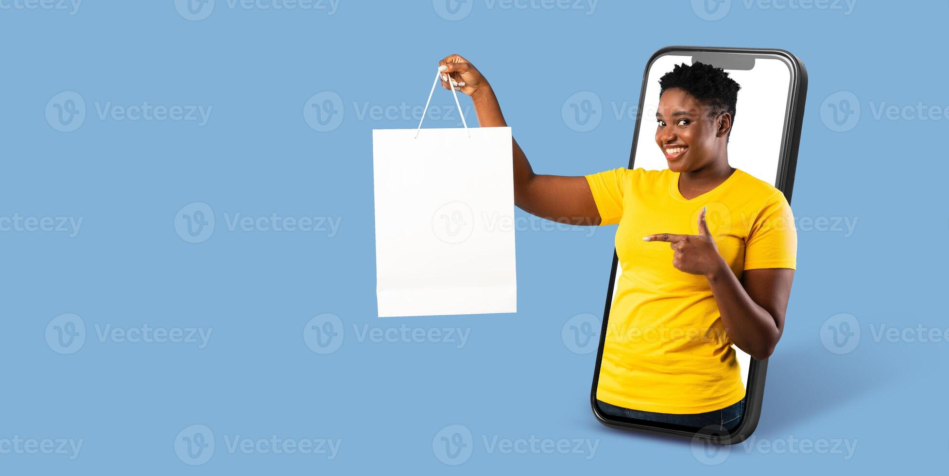 A buyer uses a large smartphone to engage in online shopping, happily showcasing a shopping bag. The setting features a clean, isolated background that emphasizes the activity. photo