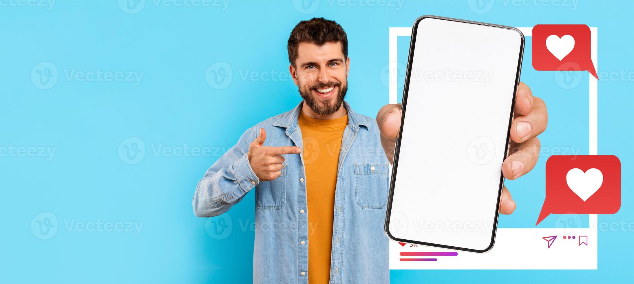 An influencer is holding a smartphone with a blank screen, smiling and pointing at it. The background is light blue, and there are social media icons nearby, emphasizing online communication. photo