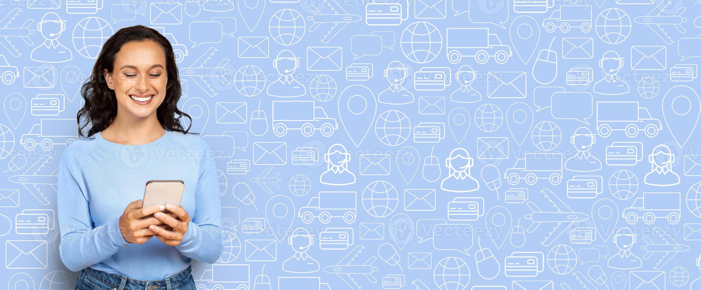 A customer smiles while using a smartphone to shop online in an interactive digital environment filled with shopping icons and symbols representing commerce and delivery services. photo