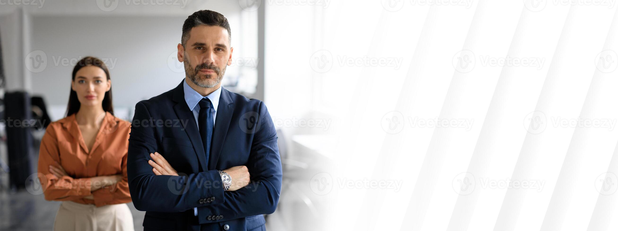 Two professionals stand confidently in a sleek office environment, copy space photo