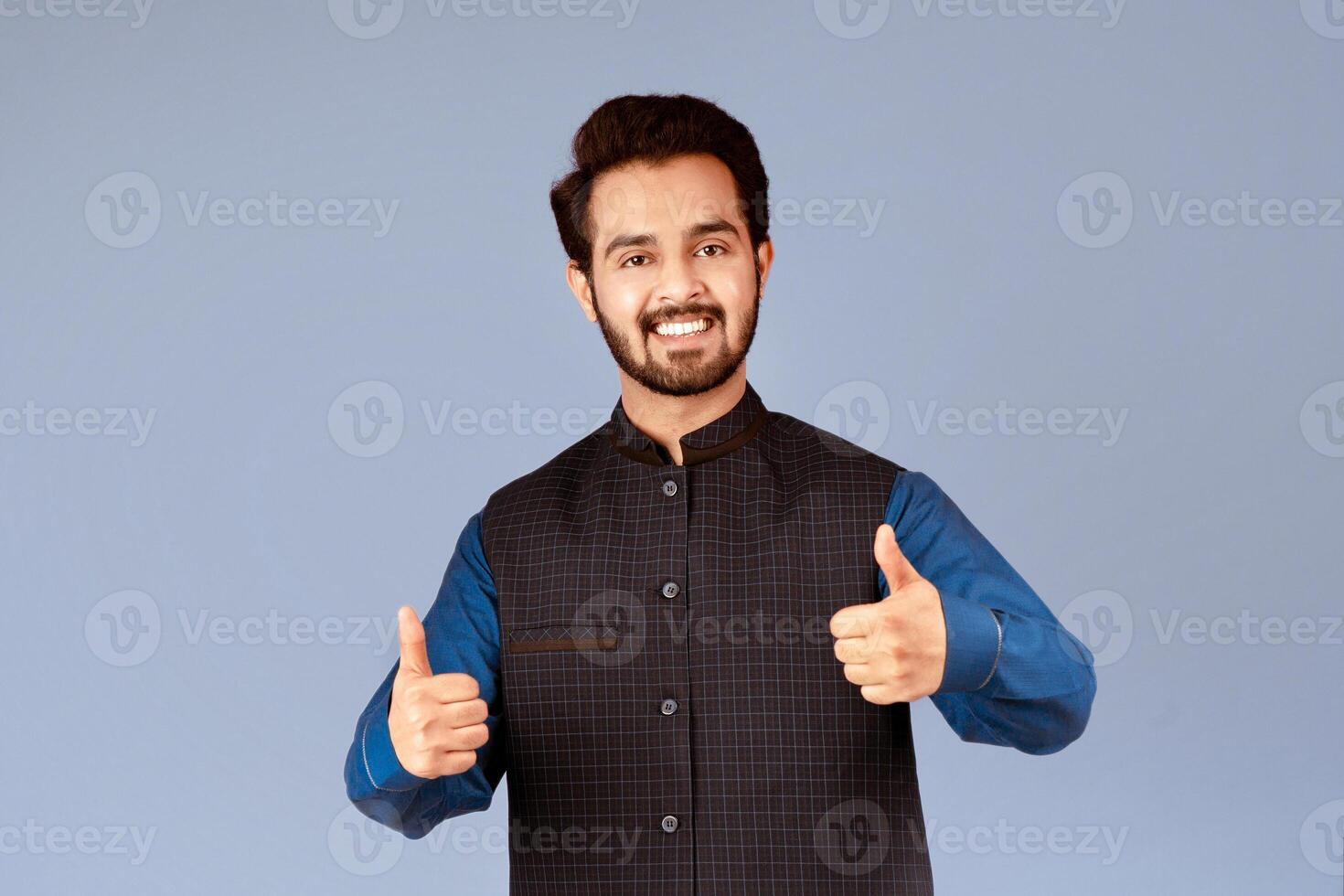 Happy Indian guy showing thumbs up gesture, expressing positivity over lilac background. Panorama photo