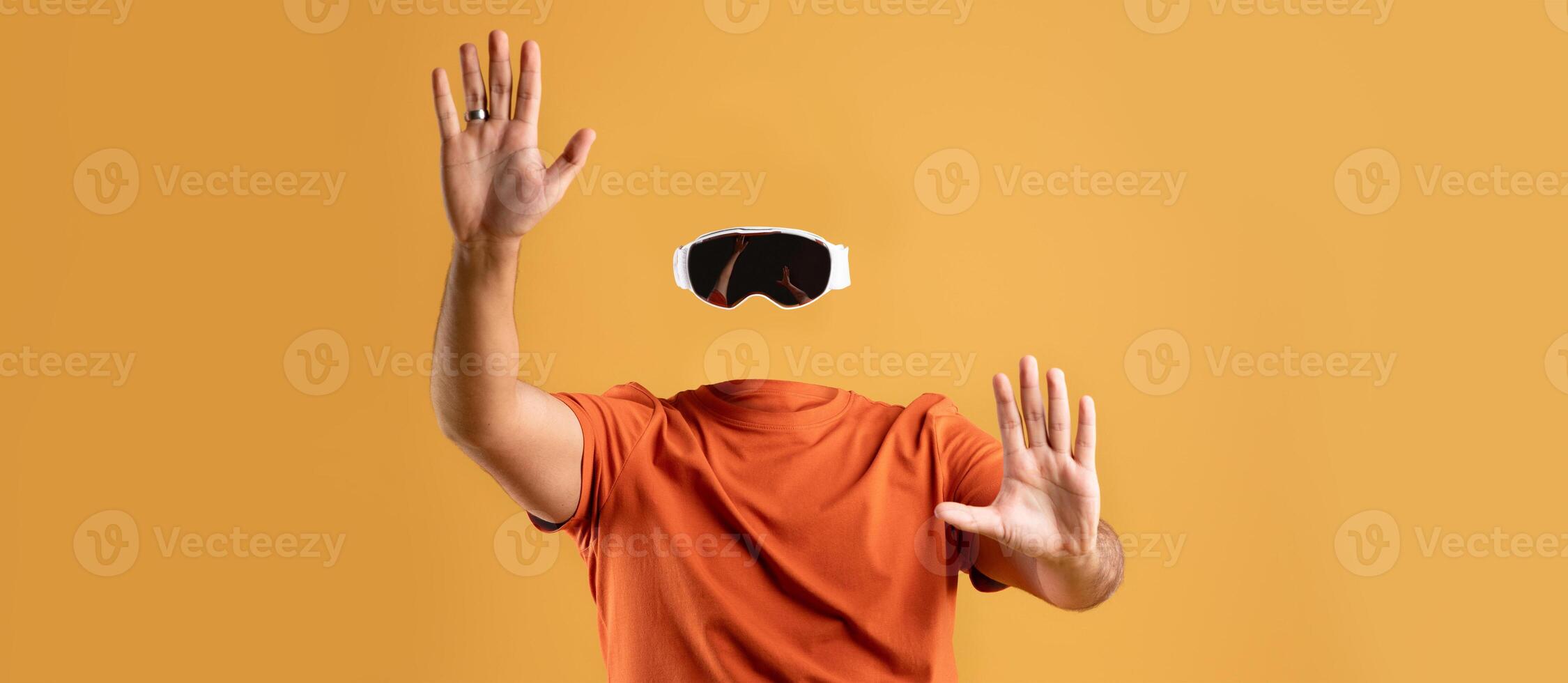 A user enthusiastically engages with virtual reality technology while wearing goggles, showcasing a dynamic and modern approach to immersive experiences. The background is a vibrant yellow. photo