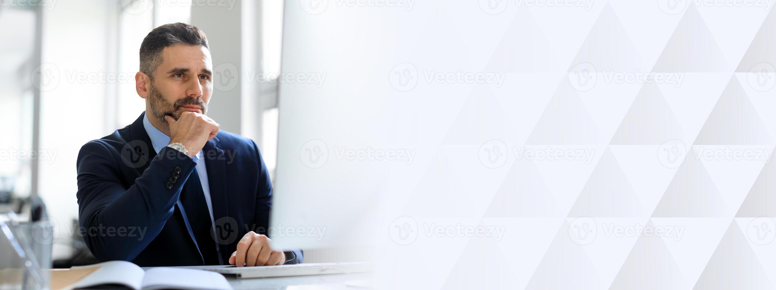 Middle aged businessman in a suit sits at his desk, deep in thought, contemplating decisions in a well-lit, modern office environment with ample copy space available, copy space photo