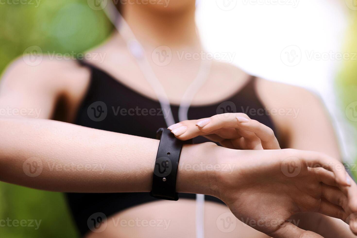 Gadgets For Sport. Female athlete using smartwatch outdoors to track her training progress, closeup image with selective focus photo