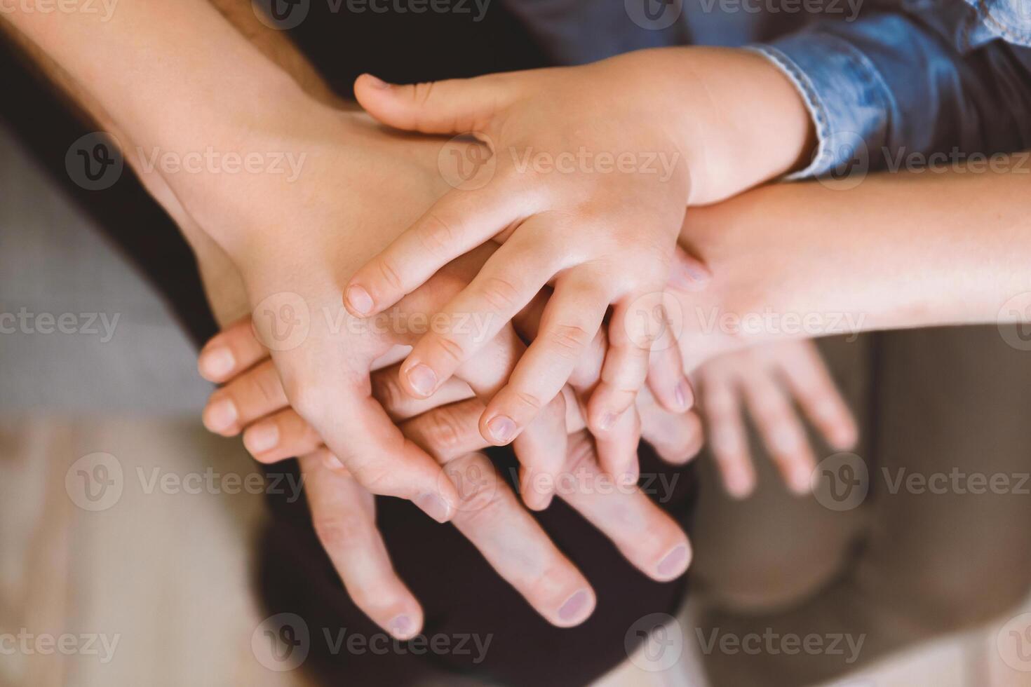 Family Bond. Parents And Kids Holding Hands Together Indoors. Cropped, Closeup, Selective Focus photo