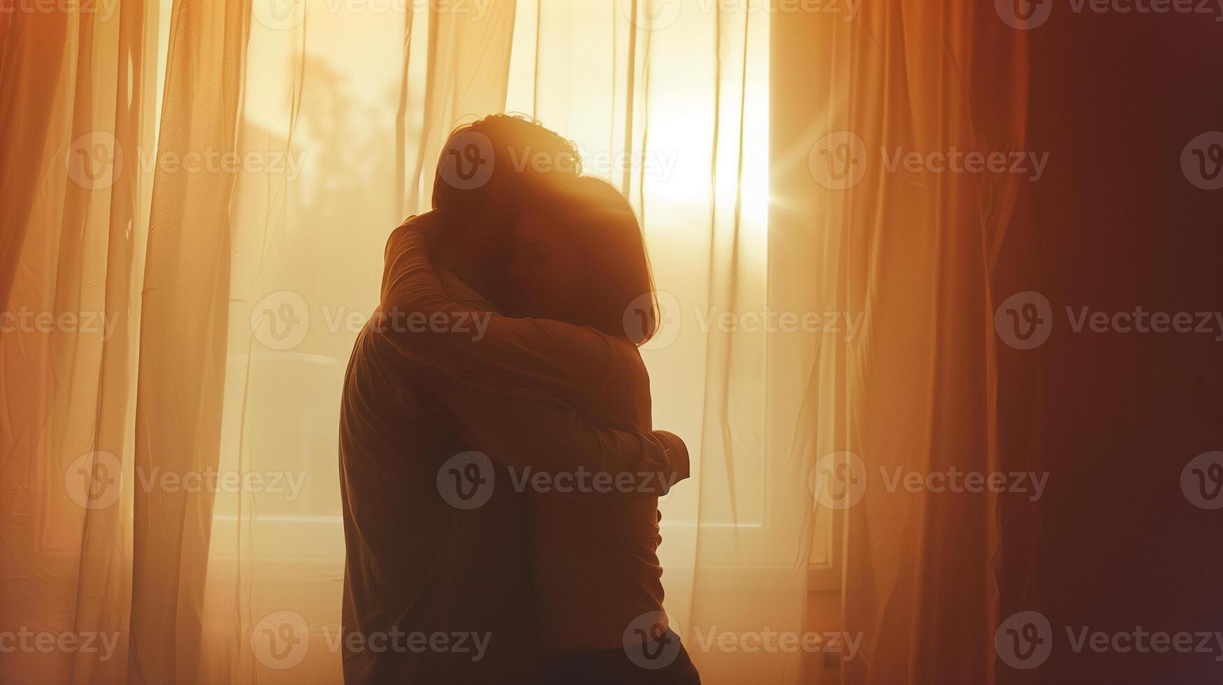 This Two people embrace in a warm, sunset glow, symbolizing their reconciliation. photo