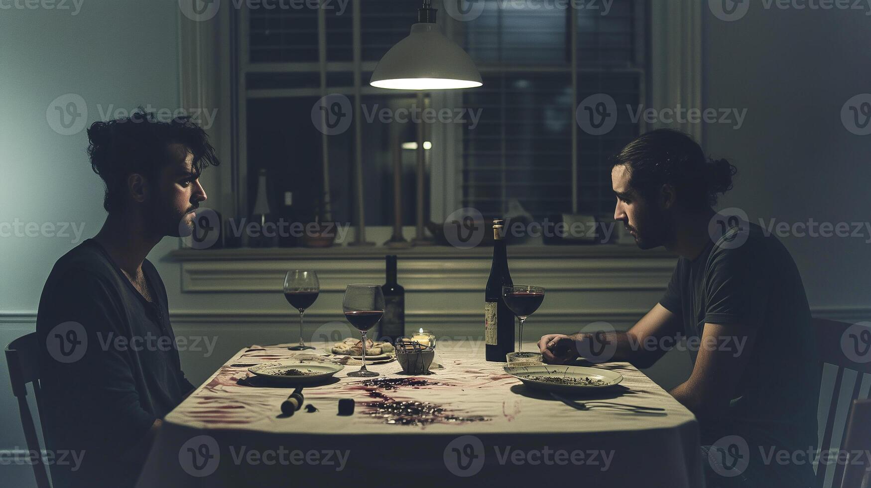 This Two tense men sit silently at a table, hinting at an underlying disagreement. photo