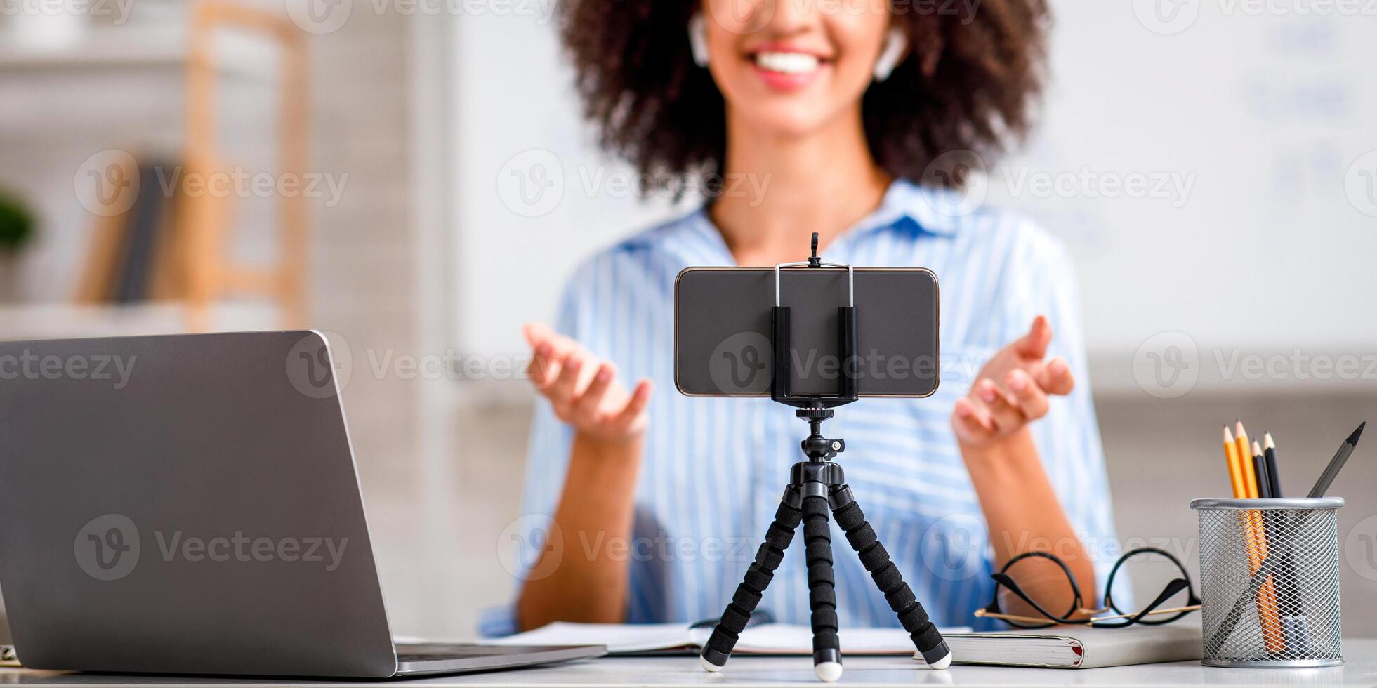 Educational training in class and lecture online. Tutor look at webcam, teach by device in interior of living room with board during outbreak of covid-19 photo