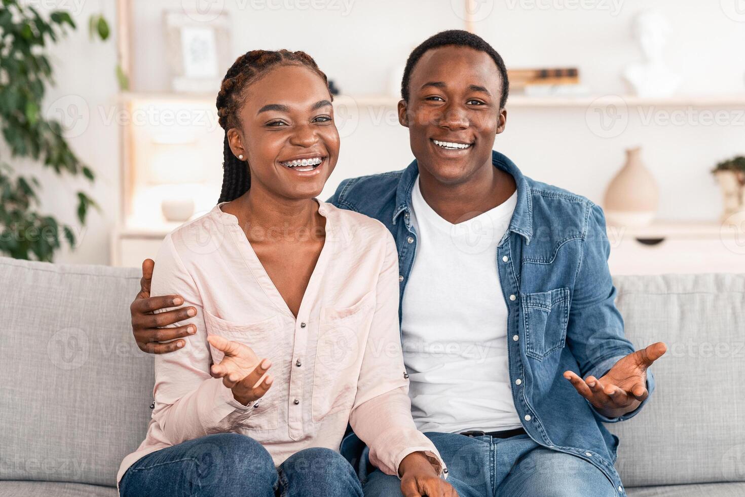 Found Compromise. Happy Black Couple Posing On Couch At Counselor's Office After Successful Therapy, Smiling At Camera, Free Space photo