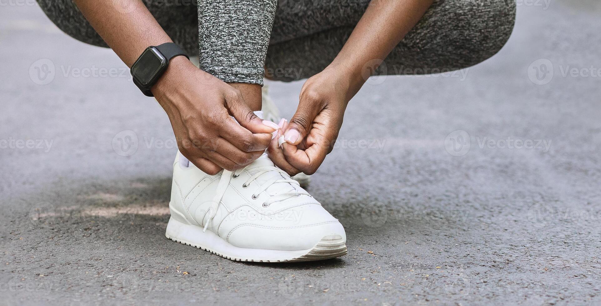 Getting Ready For Jogging. Sporty Black Couple Tying Sneaker Laces Before Running In Park, Cropped Image With Free Space photo