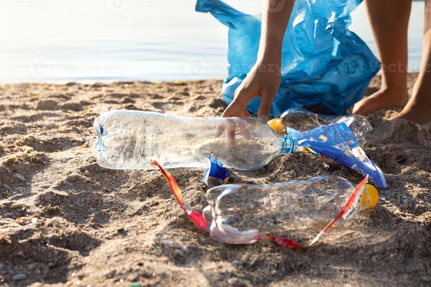 Volunteer Girl Picking Up Wasted Plastic Trash Cleaning Polluted Beach Outside. Cropped, Empty Space For Text photo