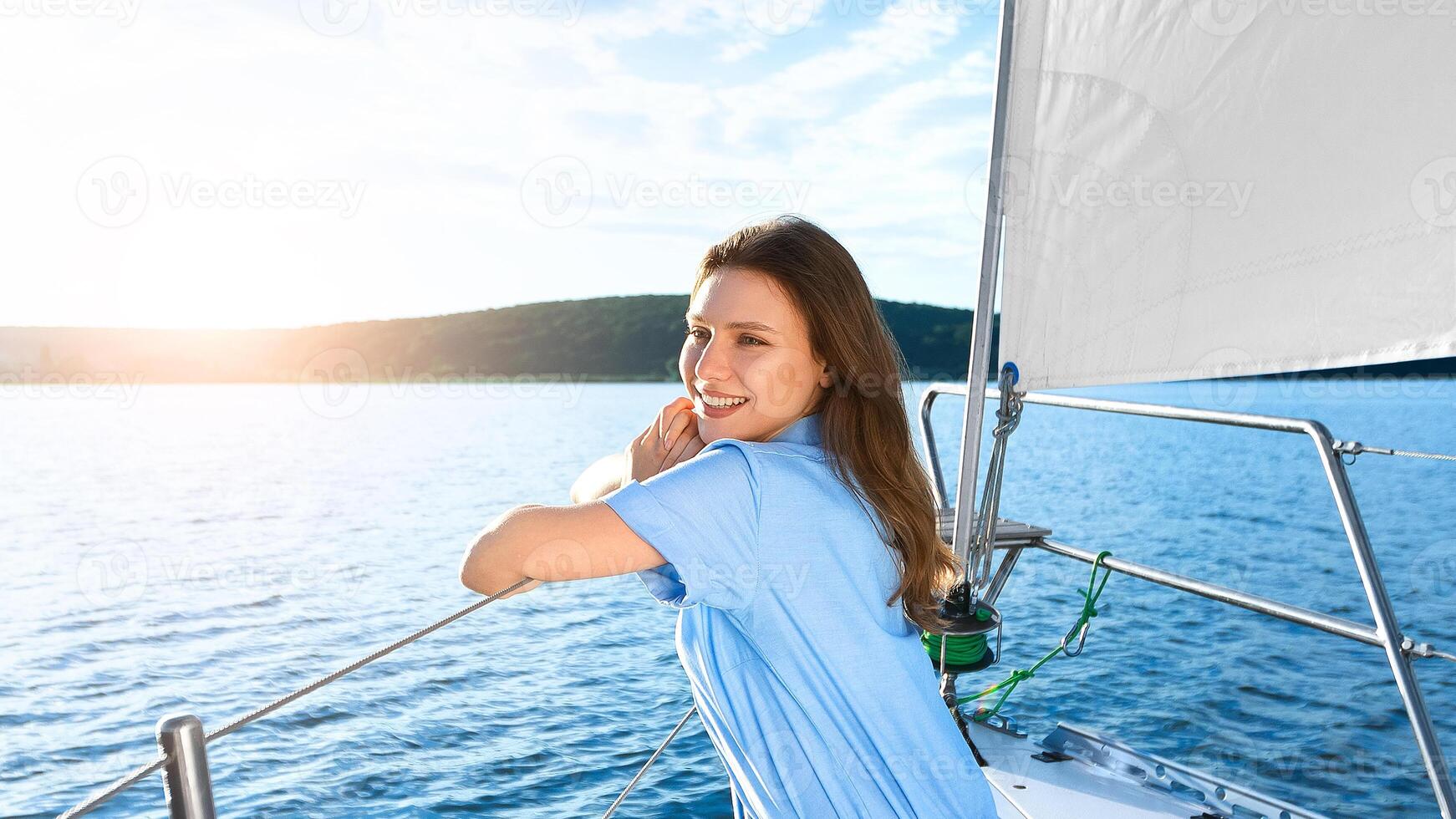 Woman Sitting On Yacht Deck Relaxing Looking At Sea Enjoying Summer Day On Water Sailing Outdoors. Dream Vacation. Copy Space photo