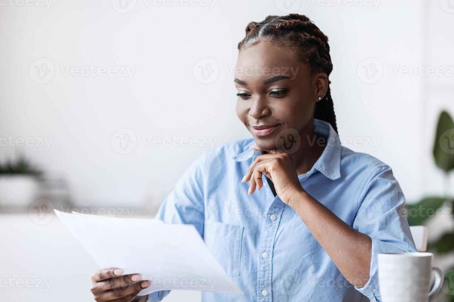 Ambitious Black Female Entrepreneur Working With Business Documentation In Office, Sitting At Desk, Checking Financial Report, Confident African Businesswoman Looking At Papers And Smiling, Free Space photo
