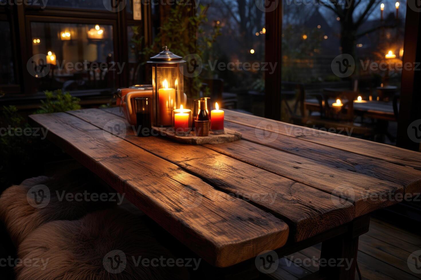 A table with candles and a bottle of wine photo