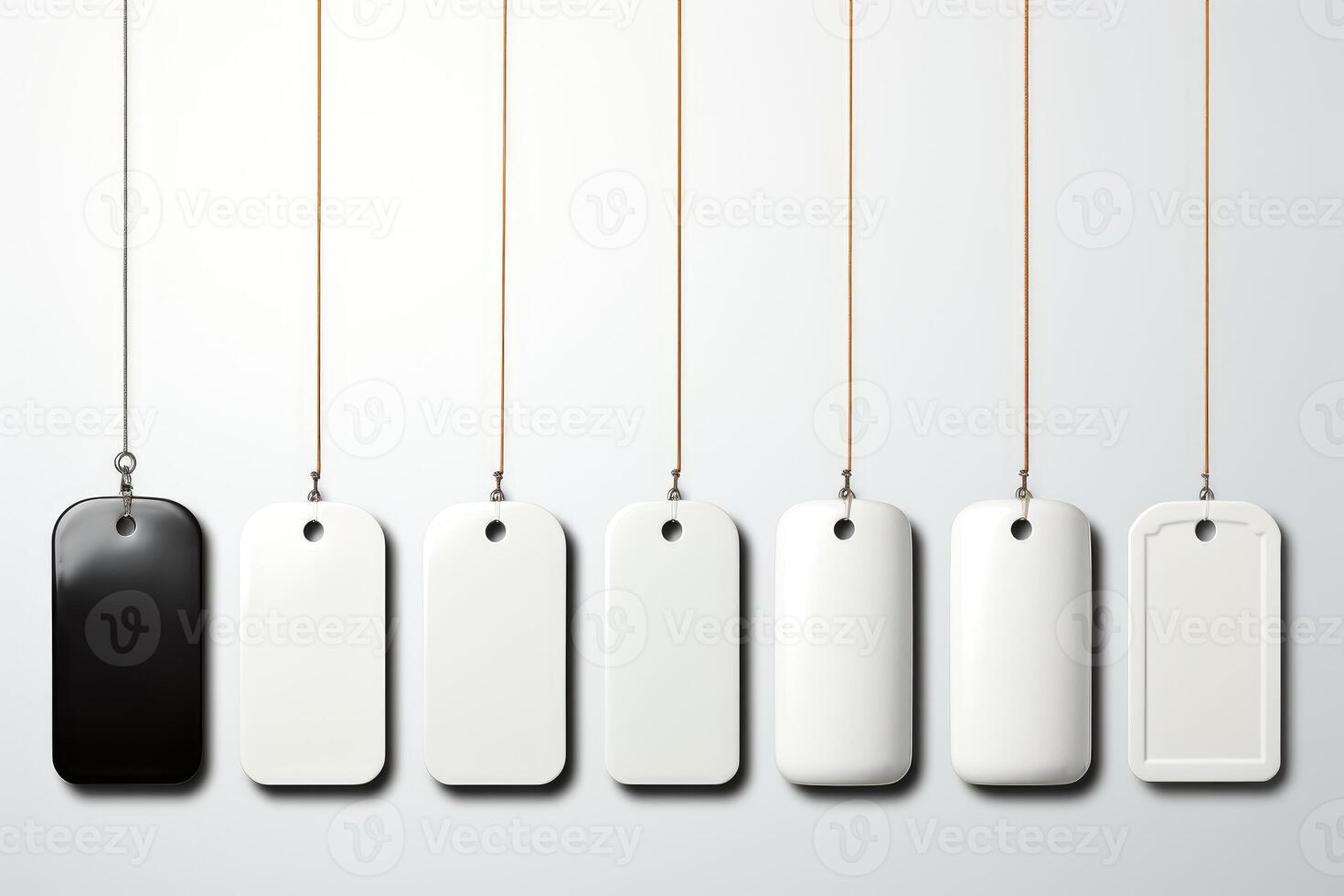 White blank tags hanging on strings on a white background photo