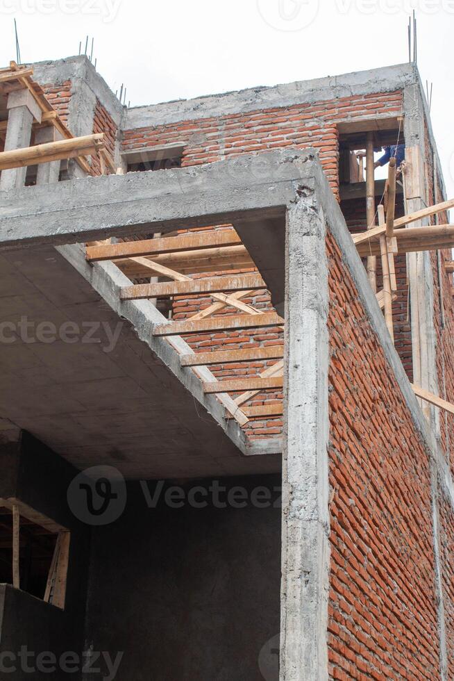 A building under construction with red brick and cement photo