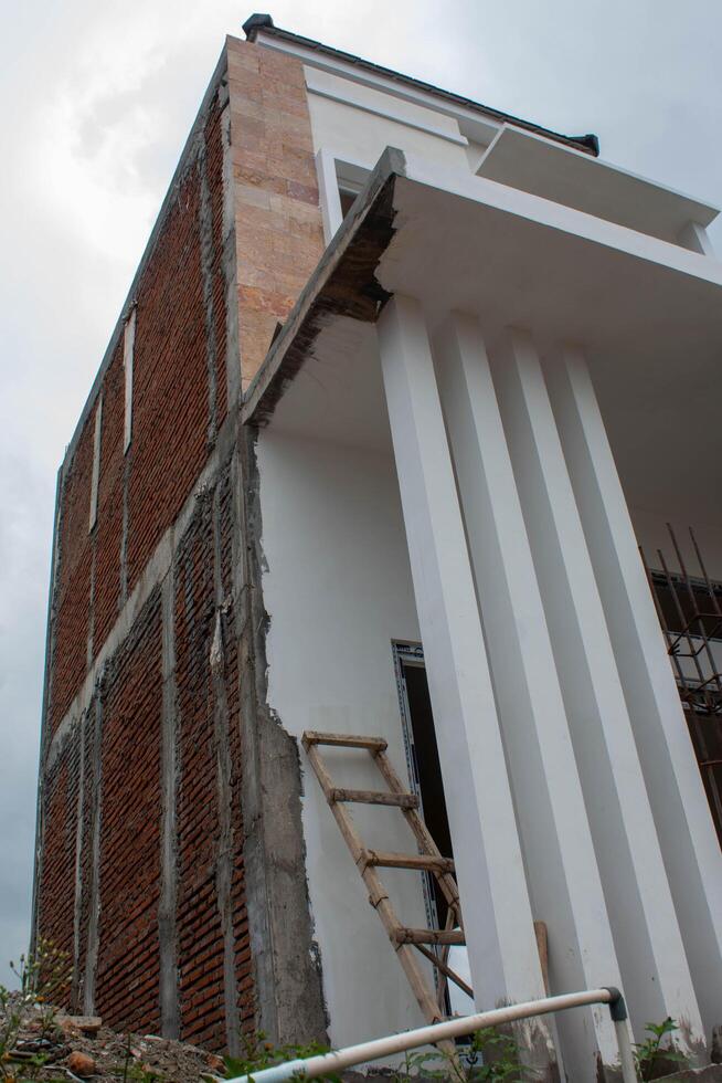 Contemporary luxury home showcasing a sleek glass balcony extending from the master bedroom suite under construction photo