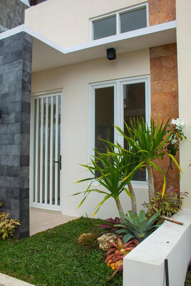 Contemporary house facade with large glass windows and sleek concrete finishes photo