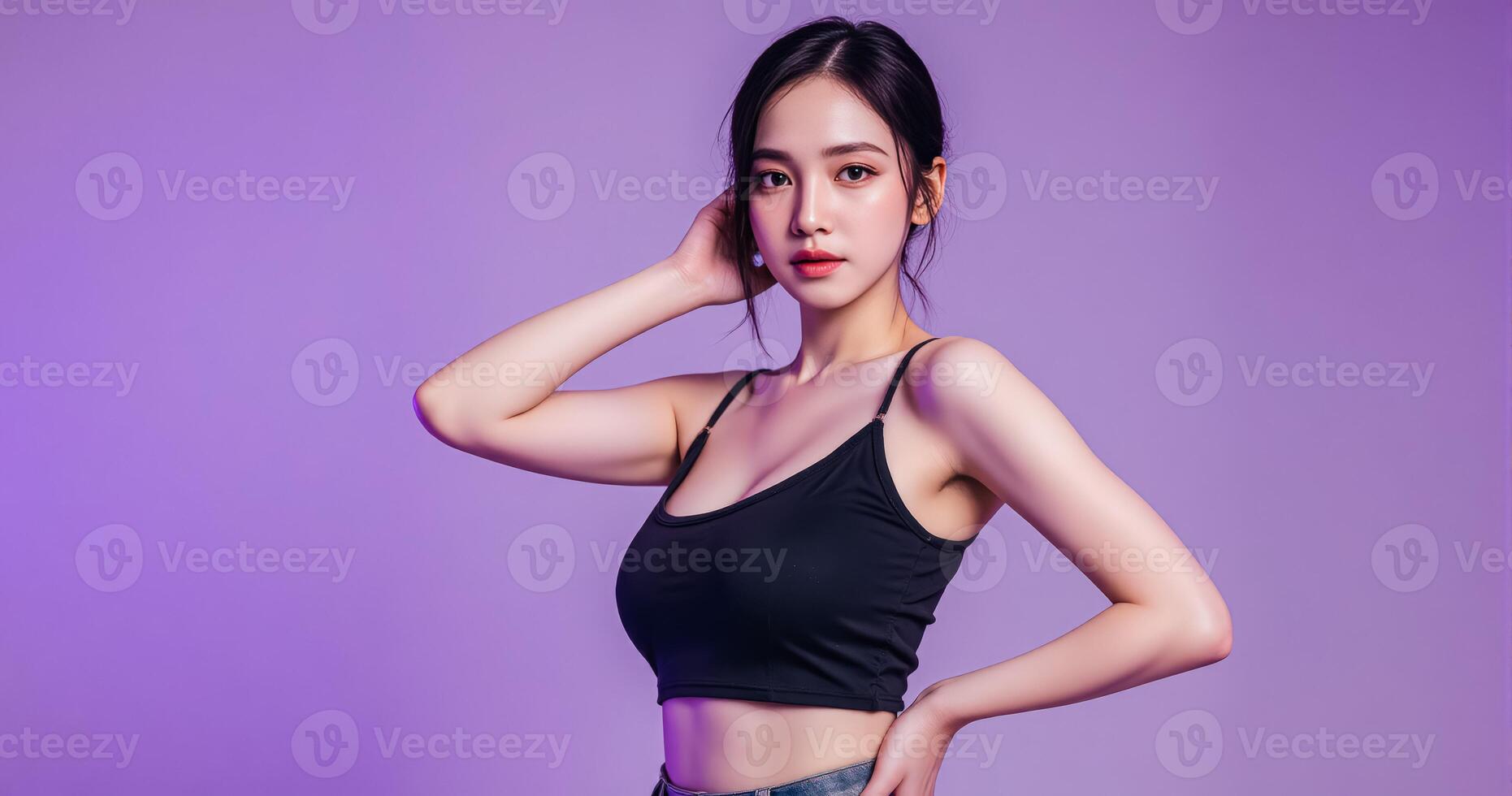 A woman in a black top posing against a purple background photo