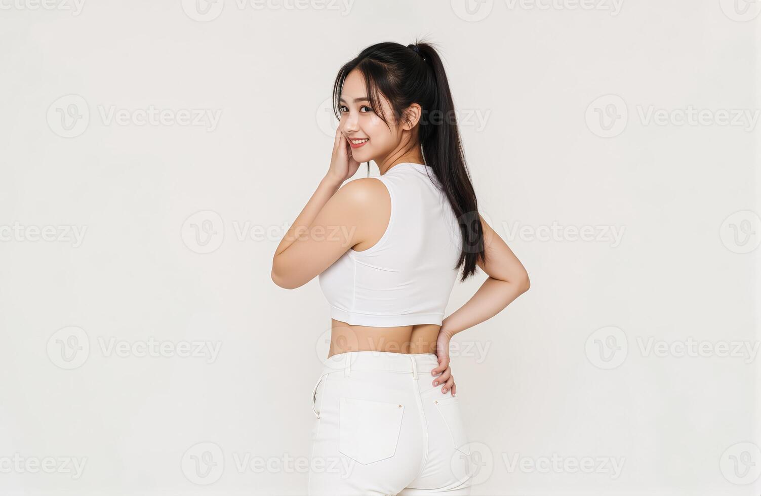 Back view of asian woman in white jeans and crop top photo