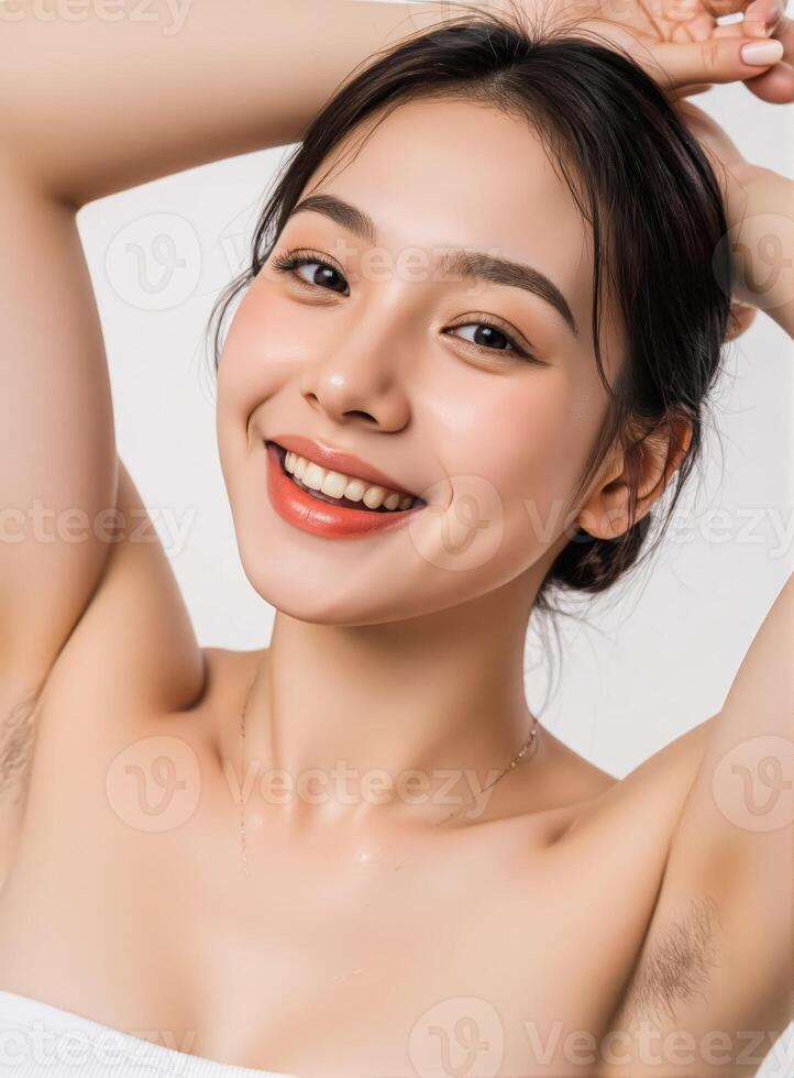 Beautiful woman with waves reveals perfect underarms raising hands white backdrop photo