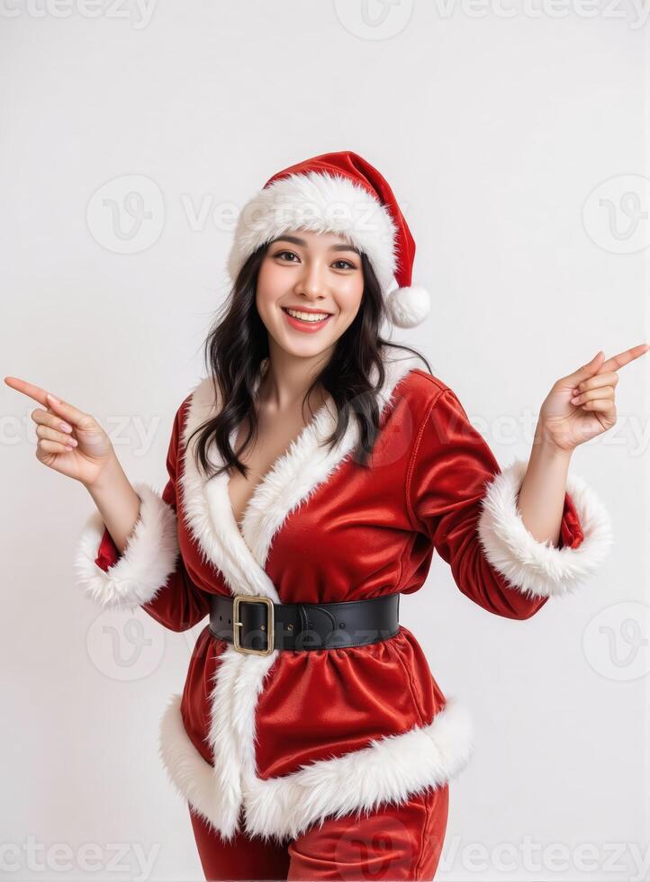A woman in santa claus suit pointing at something photo