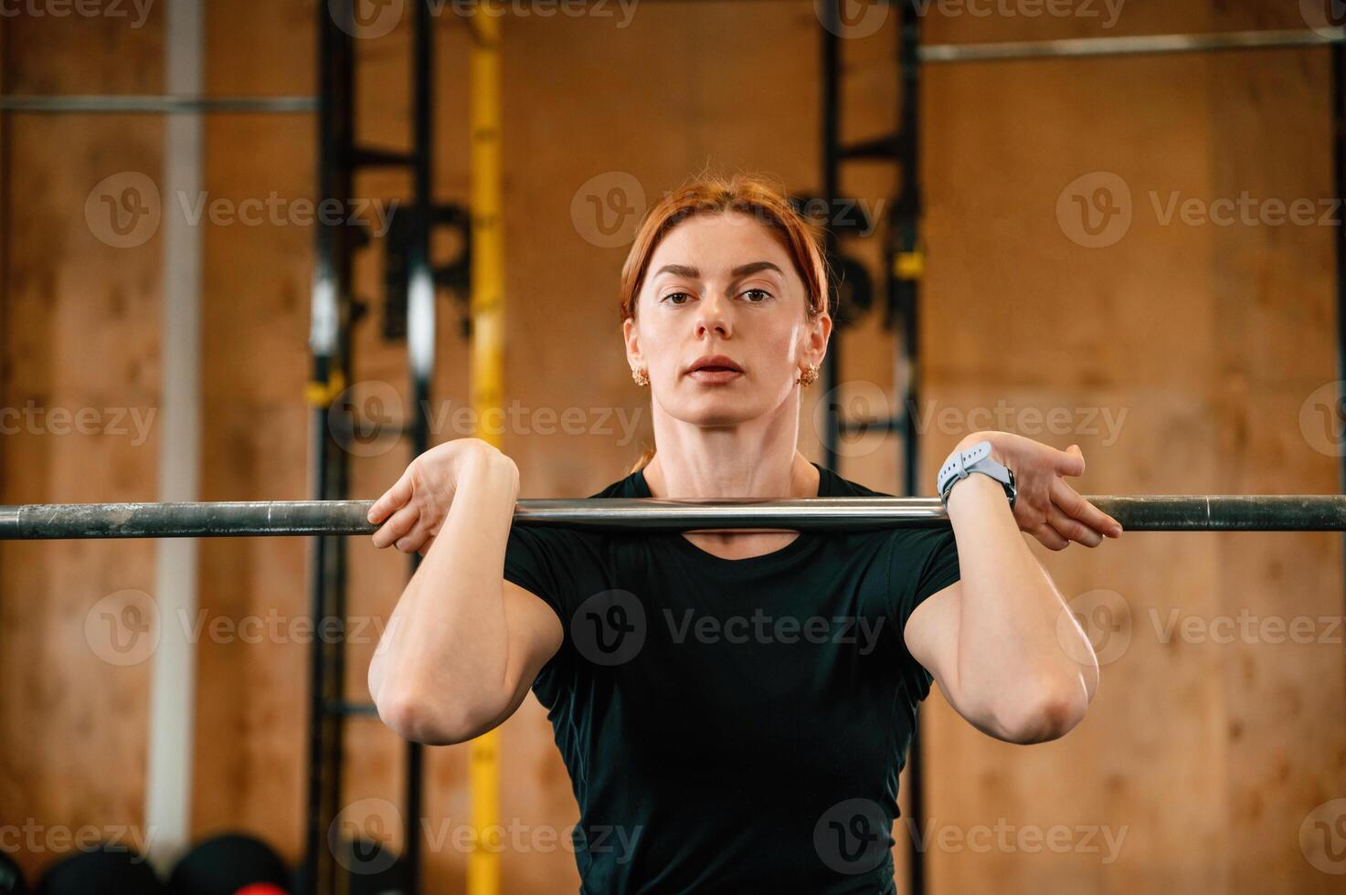 Lifting the, barbell. Beautiful strong woman is in the gym photo