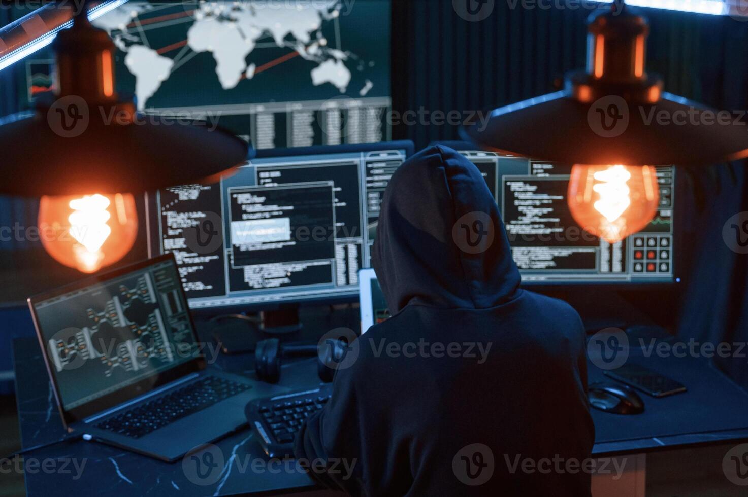Information, on screens. Young professional female hacker is indoors by computer with lot of information on displays photo